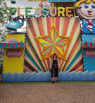 girl standing in front of striped star at dreamland margate